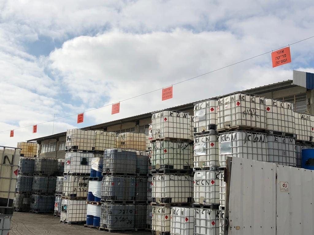 Tote containers and drums of solvents in the Mata yard